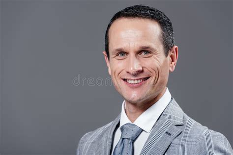Happy Adult Businessman In Grey Suit Looking At Camera Stock Image