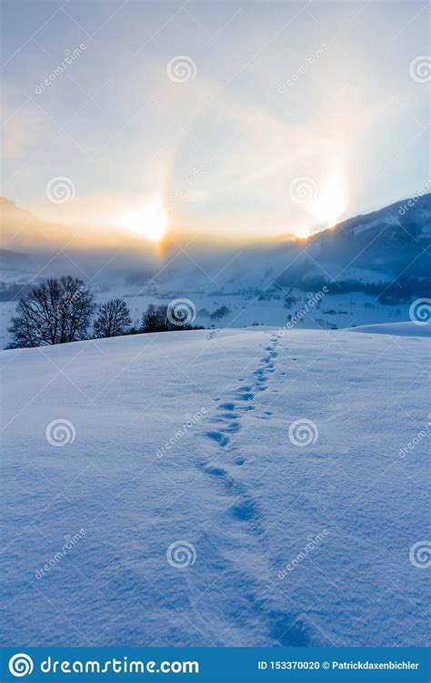 Snowy Winter Landscape In The Alps Sunrise With Halo