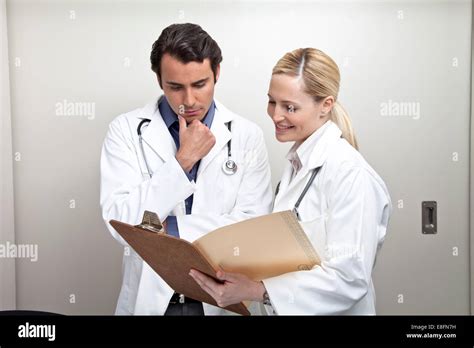 Two Doctors Examining Medical Chart In Hospital Stock Photo Alamy
