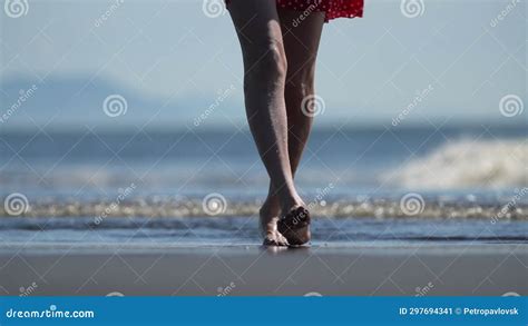 Female Bare Feet Walking On Wet Black Sand On Sandy Beach Long And Slender Stepping Woman Legs