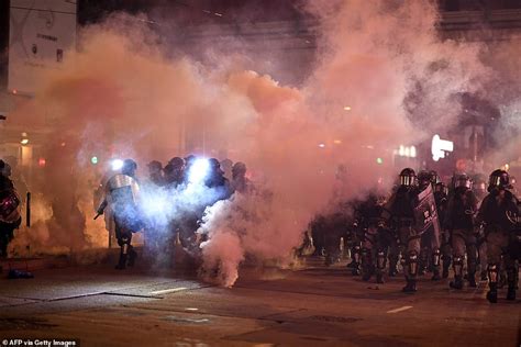 Riot Police Shoot Tear Gas At Hong Kong Protesters Who Set Fires And Built Barricades In The