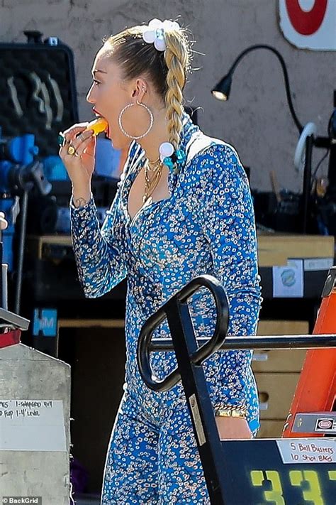 Miley Cyrus Slips Into A Plunging Blue Floral Jumpsuit As She Films