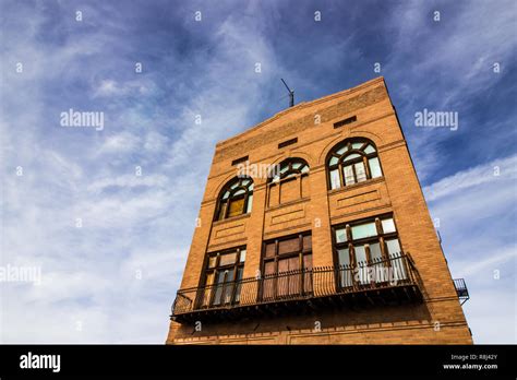 Vintage Multi Story Brick Building With Boarded Up Windows Stock Photo