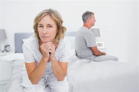 Premium Photo Thoughtful Couple Sitting On Different Sides Of Bed