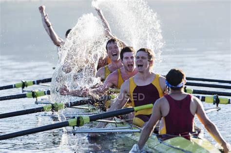 Rowing Team Splashing And Celebrating In Scull On Lake — Sculling