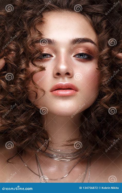 Beautiful Brunette Girl With A Perfectly Curly Hair And Classic Make