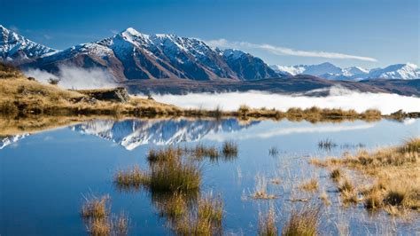 Landscape Mountains With Snow Reflecting Clouds In The Lake Queenstown