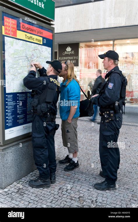 Two Czech Police Officers Assisted A Tourist On A Large Street Map Of Prague In Wenceslas Square