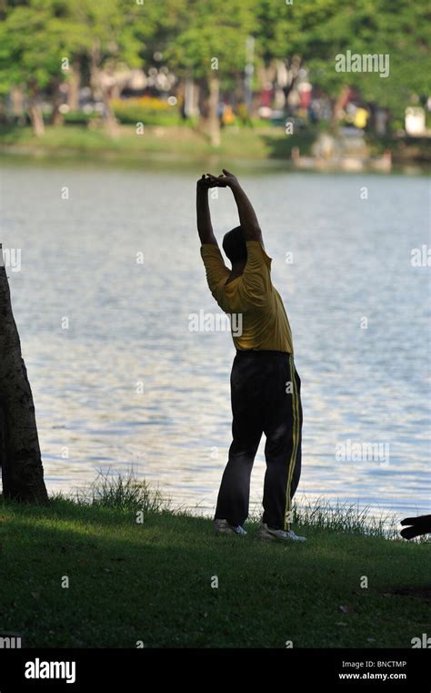 Tai Chi Exercise By Older Thai Man By The Lake In Lumpini Park Bangkok Stock Photo Alamy