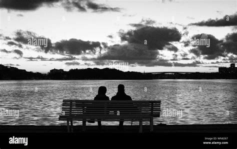 Silhouette Couple Sitting On Bench Hi Res Stock Photography And Images