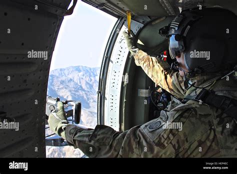 A Uh 60 Black Hawk Helicopter Door Gunner Assigned To Tf Wolfpack