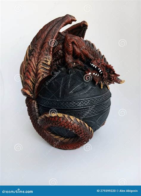 A Dragon Curled Around Its Egg Protecting It On A White Background