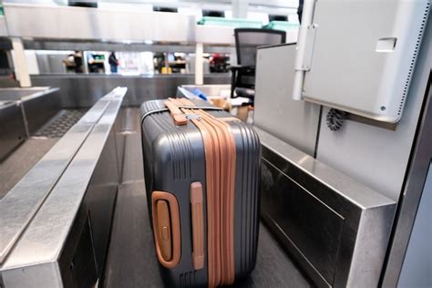 Premium Photo Suitcase On Luggage Conveyor Belt System At Check In Desk In Airport