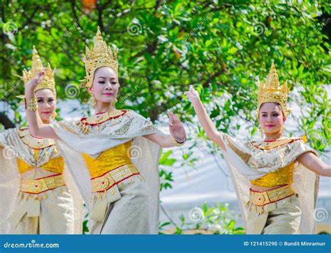 thai traditional dance with beautiful woman on golden cultural costume performing on the stage