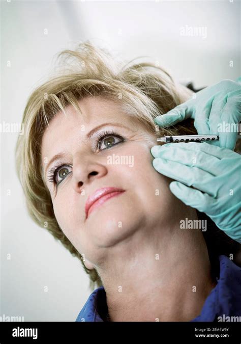 Close Up Of A Mature Woman Getting A Botox Injection On Her Face Stock