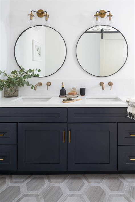 Thing you should know about bathroom mirrors and wall mirrors. Navy double vanity bathroom with brass fixtures and round ...