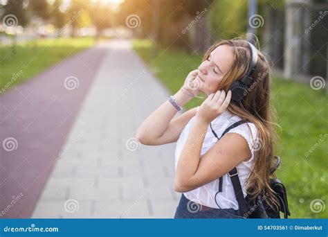 Cute Girl Enjoying Music With Headphones Outdoors Relax Stock Image