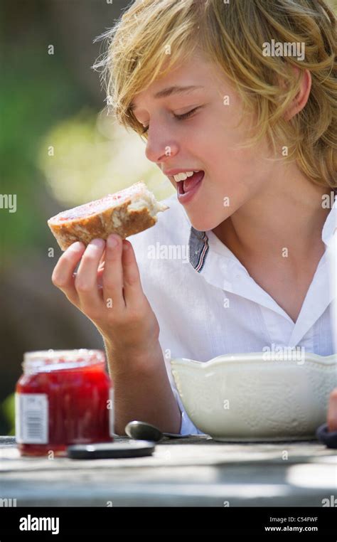 Little Boy Eating Bread With Jam Outdoors Stock Photo Alamy