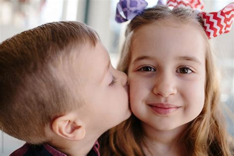 Big sister receiving a kiss from her little brother by Jakob Lagerstedt ...