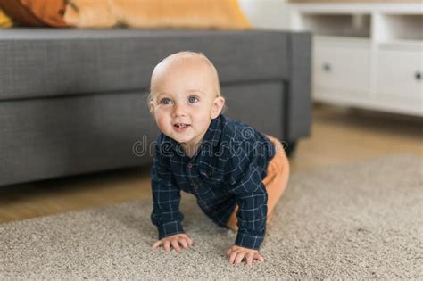 Nursery Baby Boy Crawling On Floor Indoors At Home Copy Space And Empty