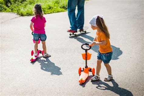 Two Little Girls On Scooters Stock Photo Image Of Ride Cheerful