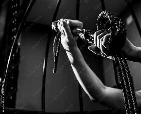 Foto De Female Hand With A Long Woven Leather Lash In A Cage Bdsm Punishment And Pleasure