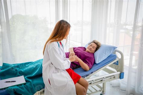 Doctor Meeting And Explaining Medication To Old Woman Patient Lying In Bed At Hospitals 6638355