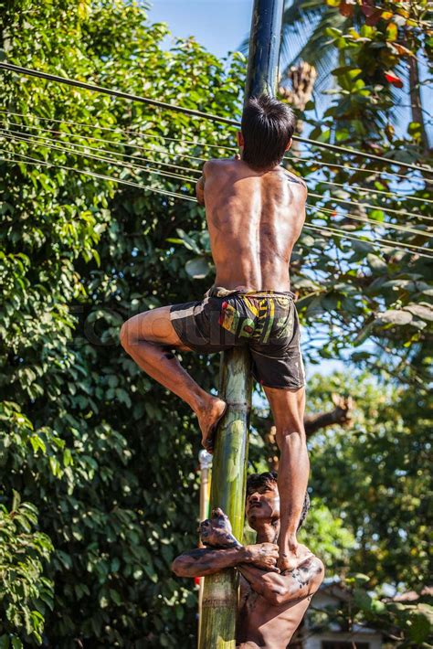 Greasy Pole Climbing Competition In Village On Myanmar Independe