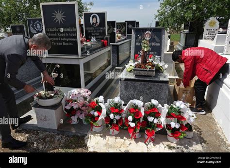 Yazidis visit the cemetery after performing their prayers at sunrise