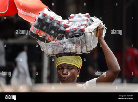 kumasi ghana jan 16 2017 unidentified ghanaian woman carries a basket with bottles of water