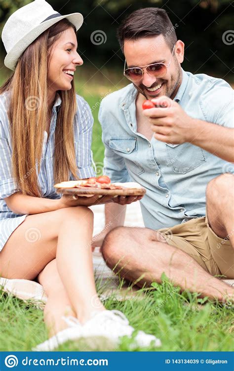Beautiful Happy Young Couple Enjoying Their Time Together Having Relaxing Picnic In A Park