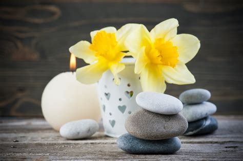 Premium Photo Balancing Pebble Stones And Yellow Flowers