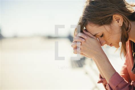 A Woman Bowing Her Head In Prayer — Photo — Lightstock