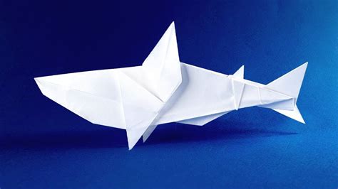 An Origami Fish On A Blue Background