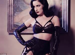 Dita Von Teese Showcases Her Burlesque Body In Black Bondage Style Lingerie And Leather Gloves