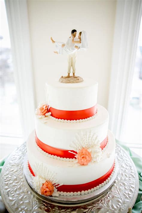 Nautical White And Orange Cake With Coral Accents Wedding Cake