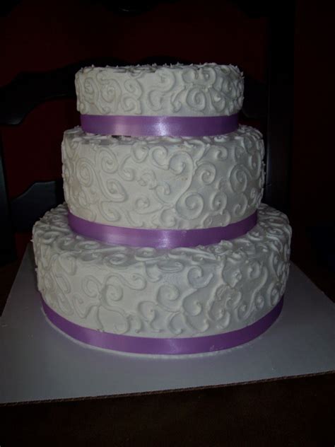 This ombre wedding cake transitions from deep red to a light cream for a festive appeal. Scroll Wedding Cake - CakeCentral.com