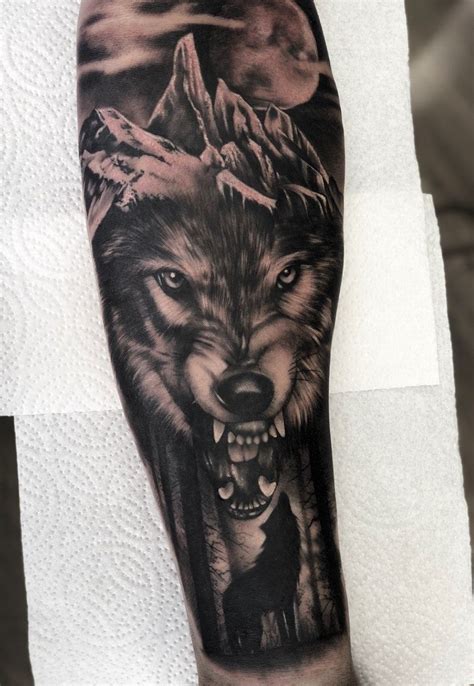 An Arm Tattoo With A Wolf On It