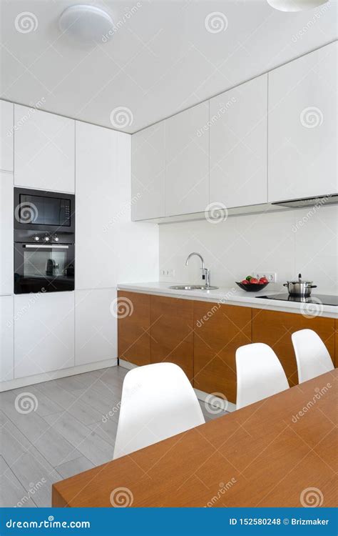 White Modern Kitchen Room With Modern Interior In Cozy Flat Stock Photo
