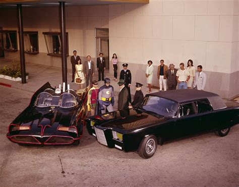 bruce lee stands beside the green hornet s car in a piece of the action
