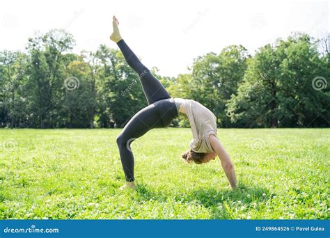 Young Woman Doing Doing Backbend Push Ups Yoga Wheel Pose In Sunny