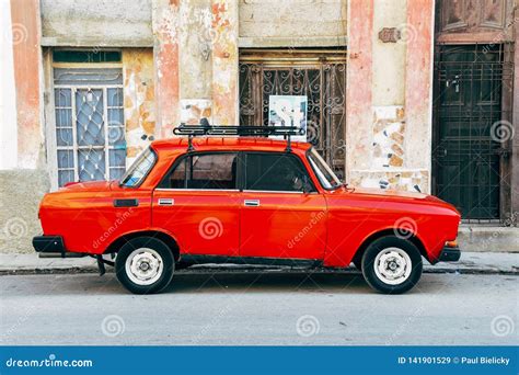 A Classic Old Red Lada Parked On The Side Of The Street In Havana Cuba
