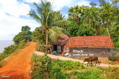 Countryside View With Village Hut And Unpaved Dirt Road At The