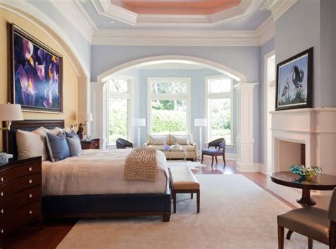 Master bedroom sitting area features caramel leather tufted accent chairs placed in front of a bed on a gray geometric rug facing a gray tufted stool. 70 Master Bedrooms with Sitting Areas (Sofa, Chairs ...