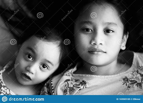 Portrait Of Asian Sisters Siblings Close Up Face On Concrete Background Stock Image Image Of