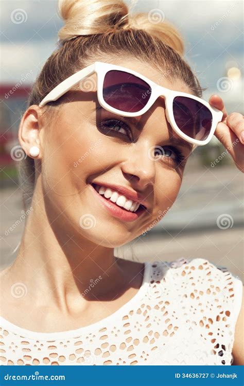 Portrait Of Beautiful Blonde Girl In Sunglasses On Background Blue Sky