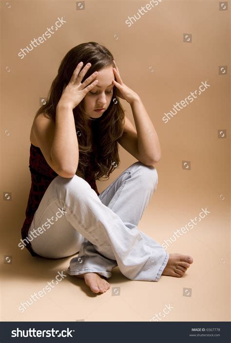 (use a foot rest or stool if necessary.) your legs should not be crossed and your feet should be flat on the floor. Teenage Girl Sitting Crosslegged On Floor Stock Photo ...