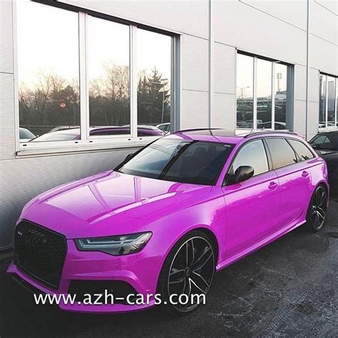 A Pink Car Parked In Front Of A Building