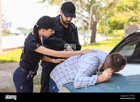 Female Police Officer Arresting Woman Hi Res Stock Photography And