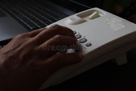Close Up Of A Businessman`s Hand Dialing Telephone Number Stock Photo